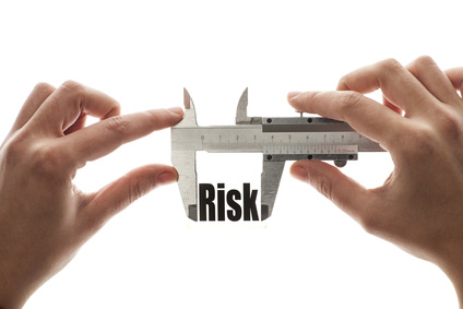 Close up shot of a caliper measuring the word "Risk"